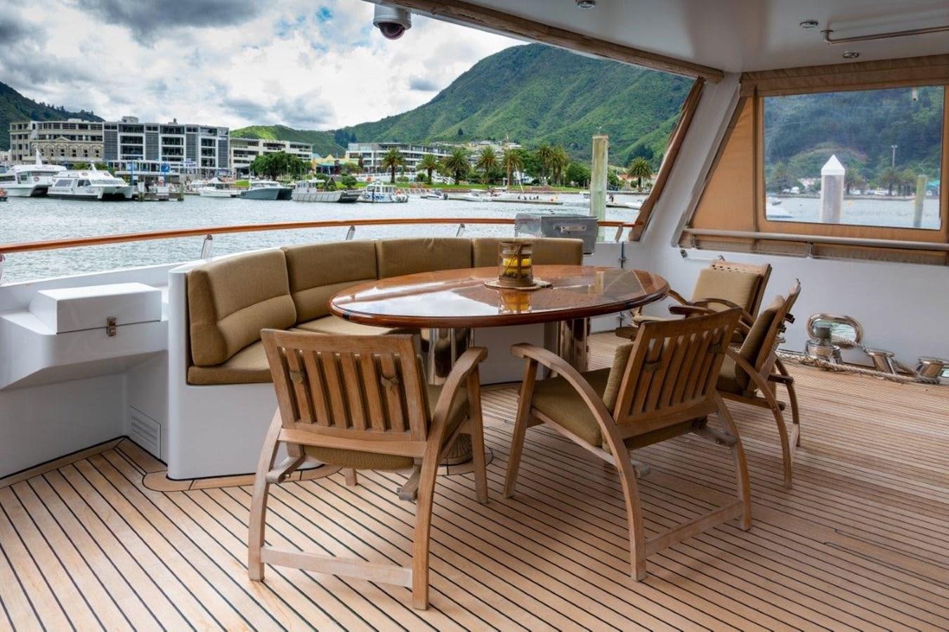 a table and chairs on a deck aboard MAVERICK Yacht for Sale