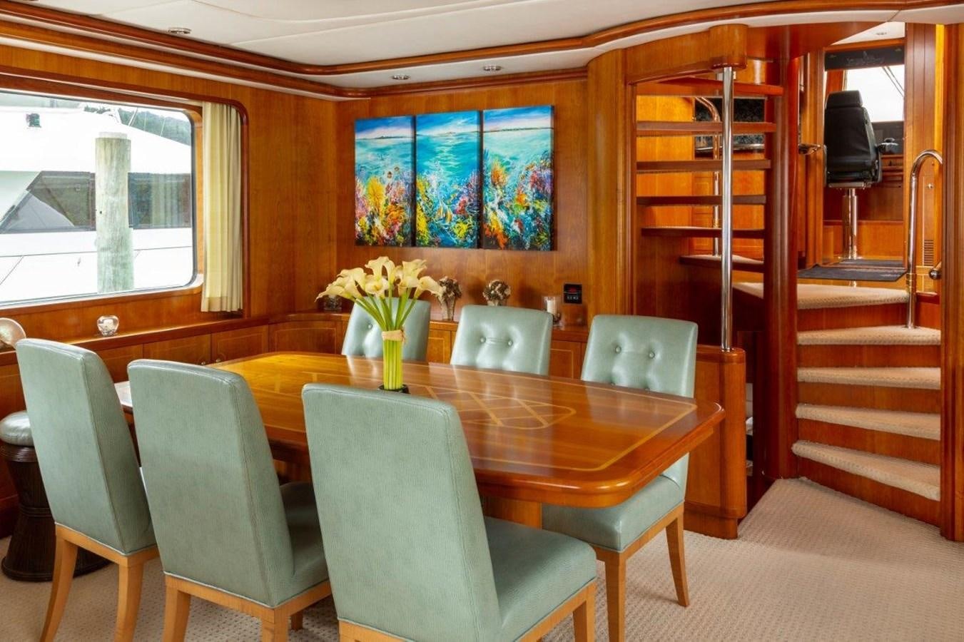 a room with a table and chairs aboard MAVERICK Yacht for Sale