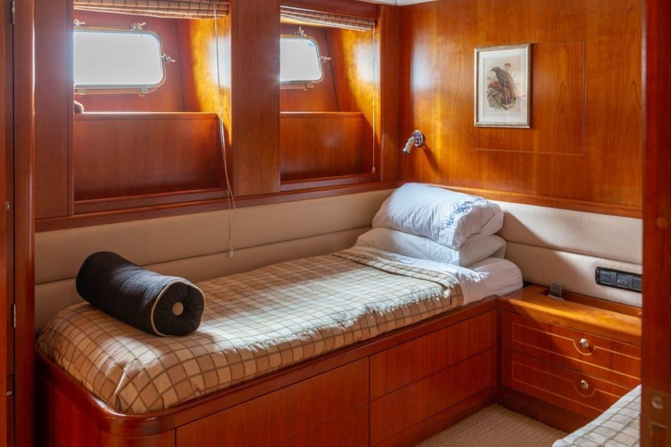 a bed with a pillow on it aboard MAVERICK Yacht for Sale