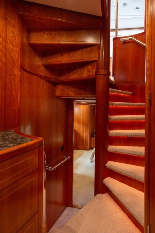 a wooden staircase in a house aboard MAVERICK Yacht for Sale