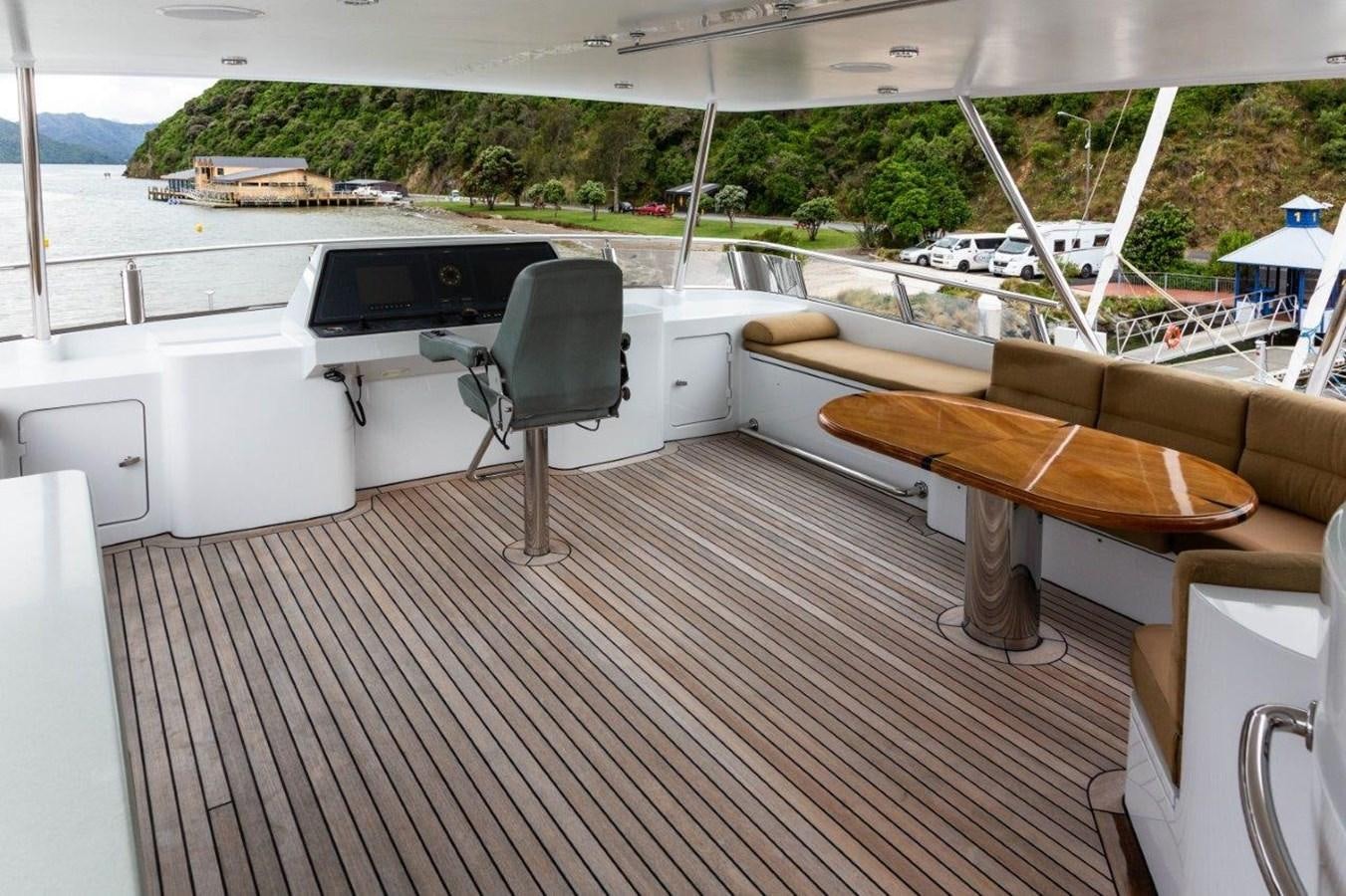 a deck with a chair and a couch aboard MAVERICK Yacht for Sale