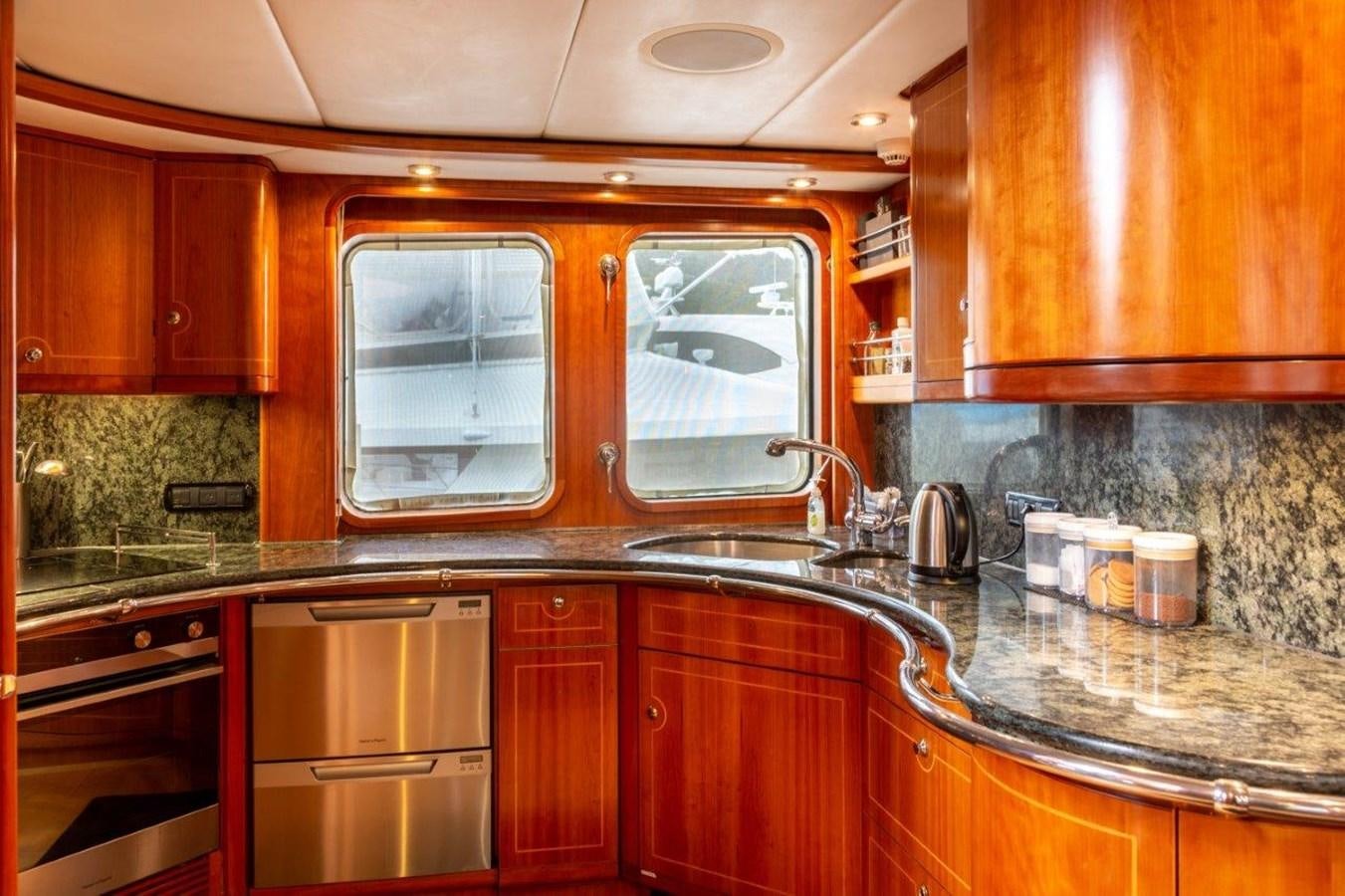 a kitchen with wooden cabinets aboard MAVERICK Yacht for Sale