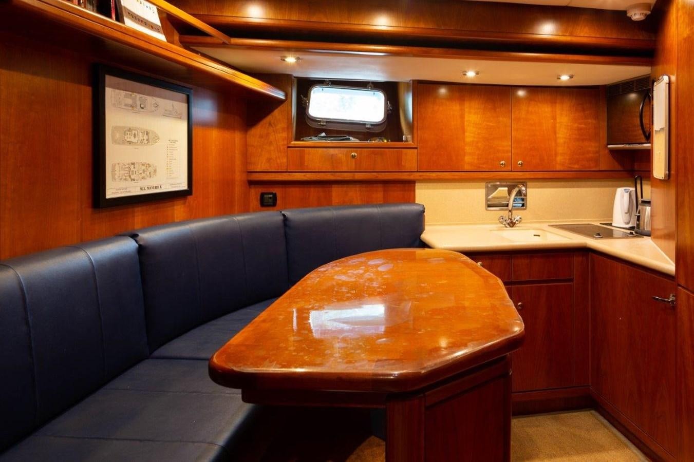 a kitchen with a couch and a table aboard MAVERICK Yacht for Sale