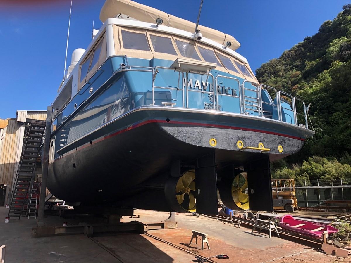a large boat on a dock aboard MAVERICK Yacht for Sale