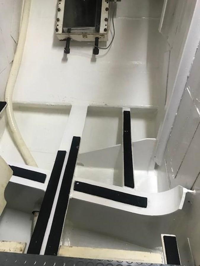 a white staircase with a black frame aboard MAVERICK Yacht for Sale