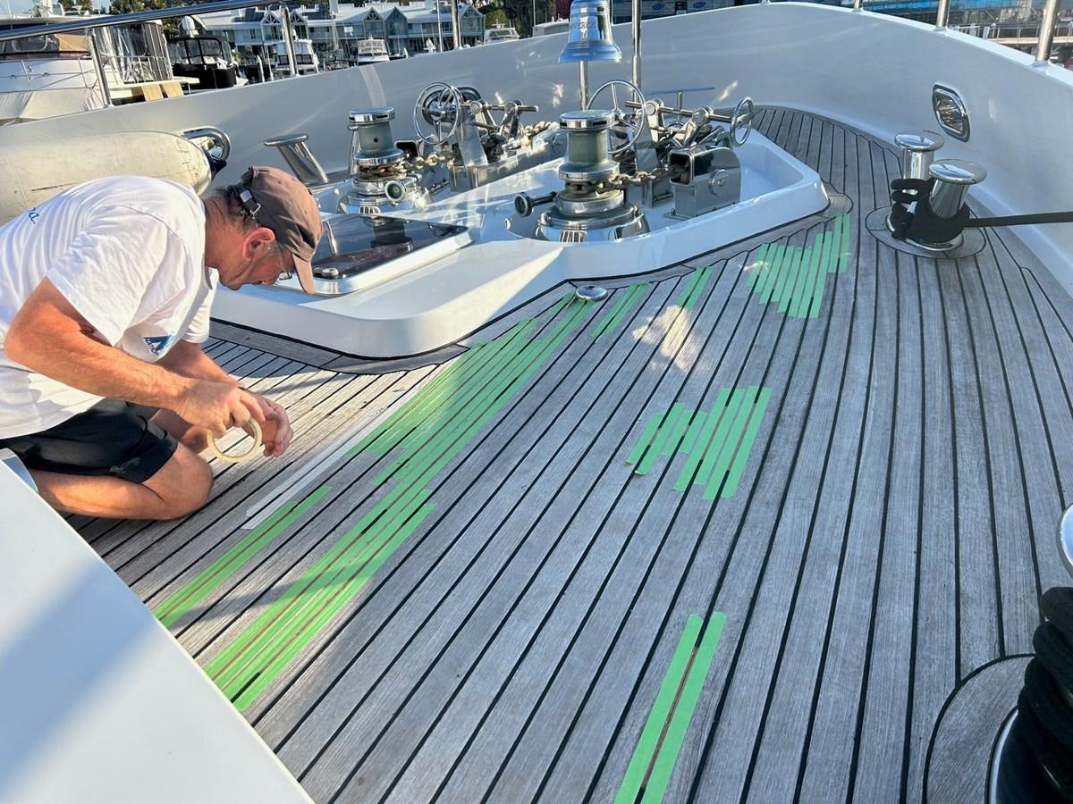 a man working on a circuit board aboard MAVERICK Yacht for Sale