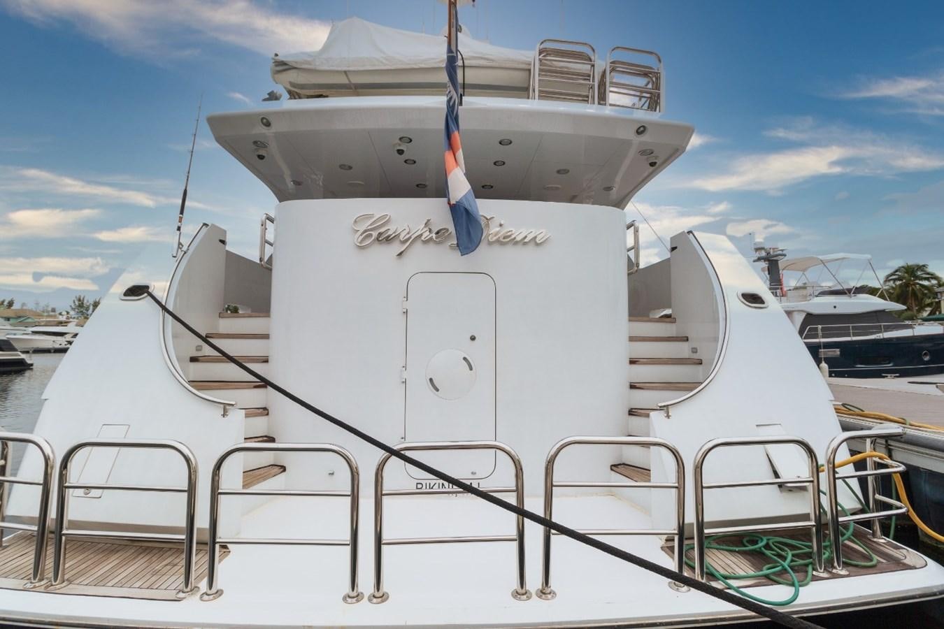 a large white ship with a blue crane on the deck aboard CARPE DIEM Yacht for Sale