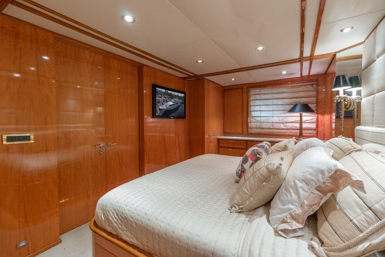 a room with a bed and a television aboard CARPE DIEM Yacht for Sale