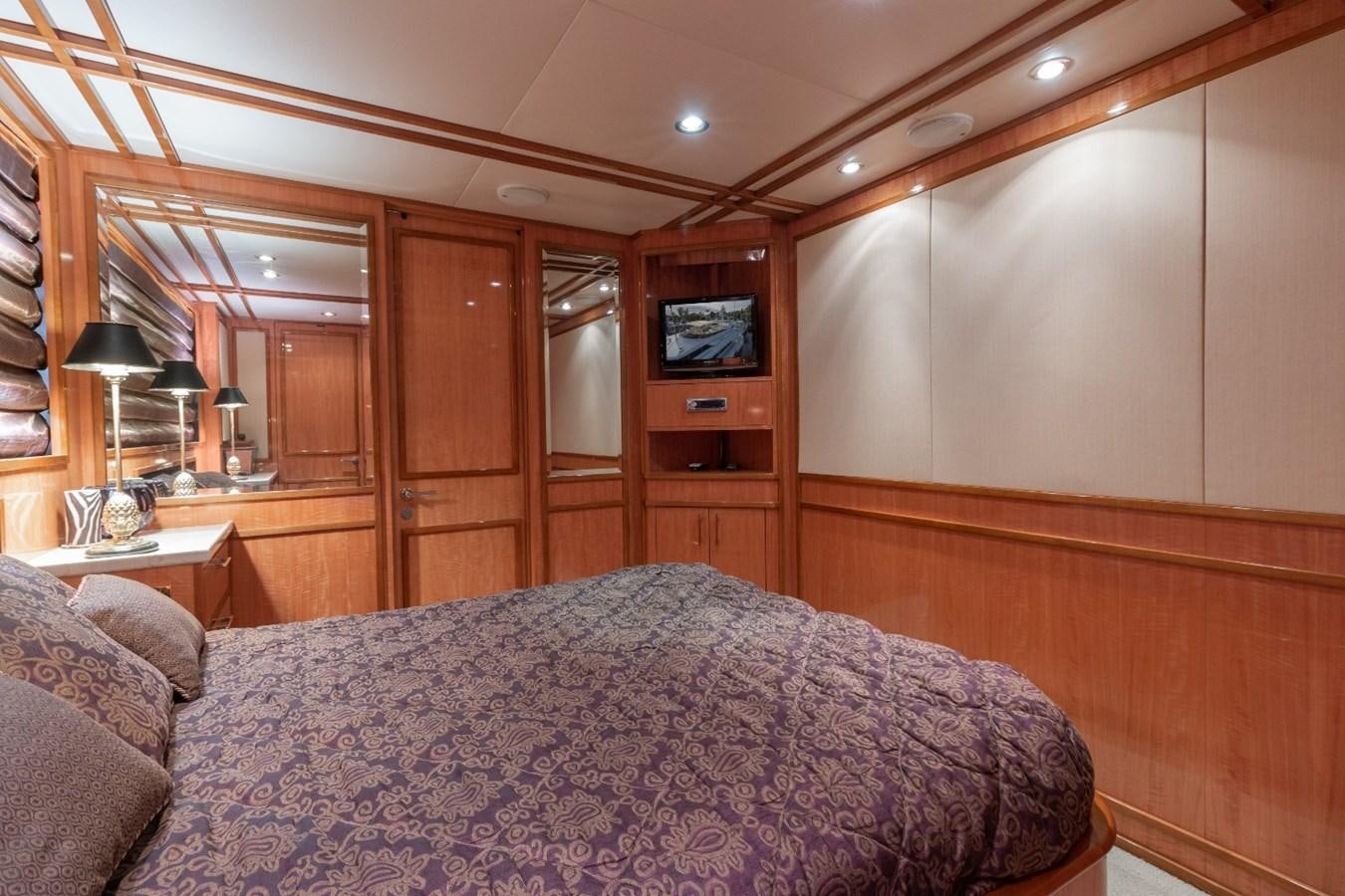 a bedroom with a bed and a television aboard CARPE DIEM Yacht for Sale