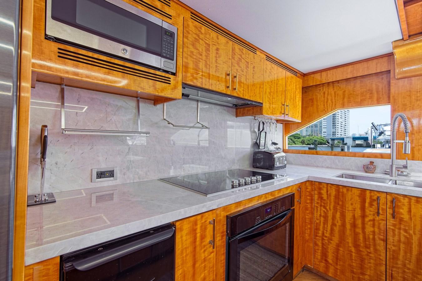 a kitchen with wooden cabinets aboard CARPE DIEM Yacht for Sale
