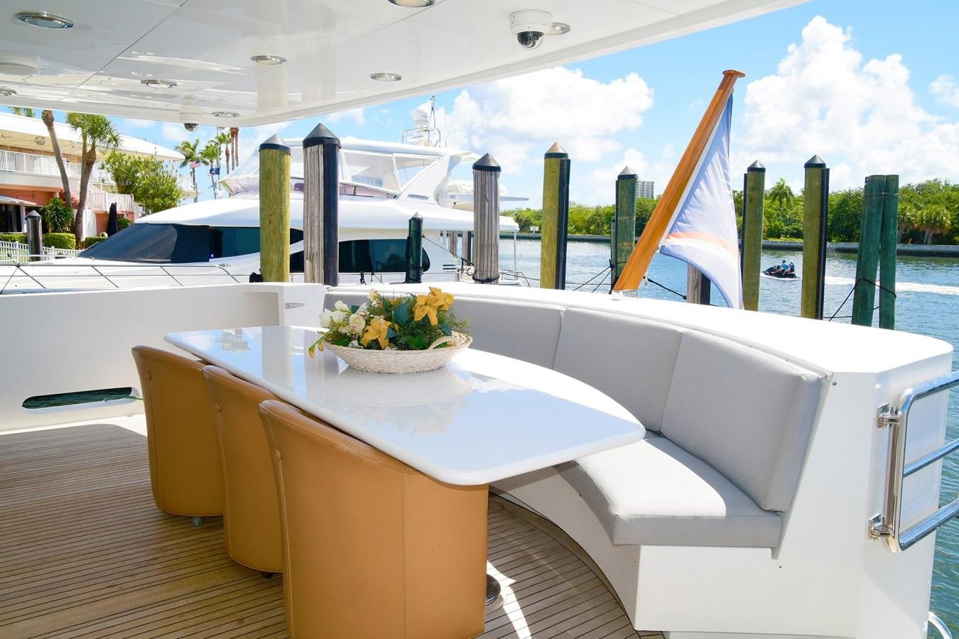 a table with chairs and a bowl of fruit on it aboard CARPE DIEM Yacht for Sale