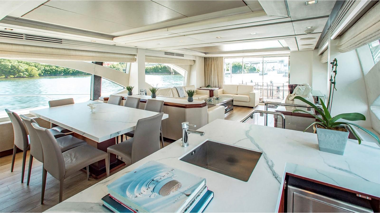 a room with tables and chairs aboard BT 2 Yacht for Sale