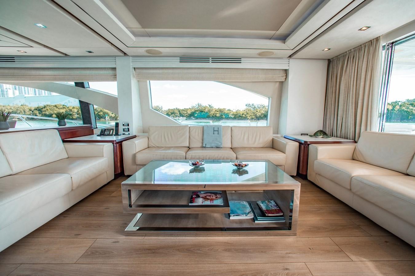 a living room with a table and couches aboard BT 2 Yacht for Sale