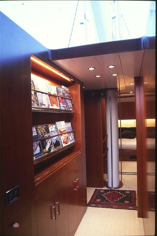 a room with a bookshelf and a glass door aboard FREE AT LAST Yacht for Sale