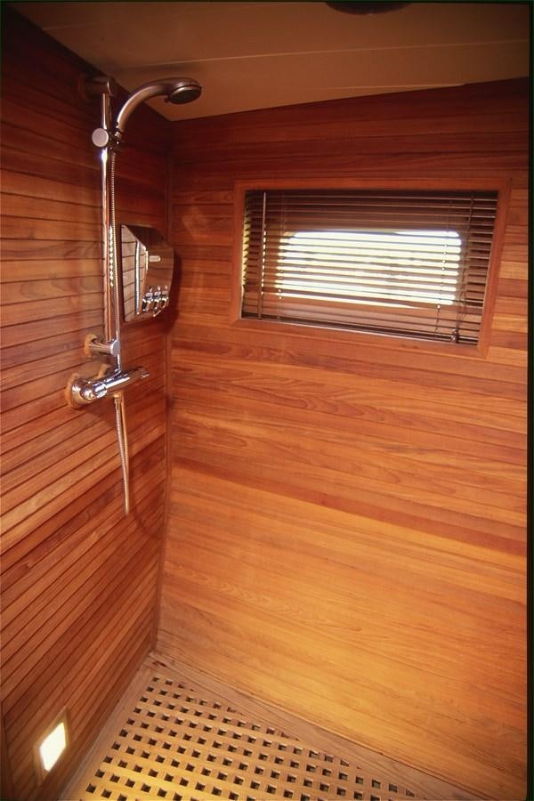 a shower head in a wooden room aboard FREE AT LAST Yacht for Sale