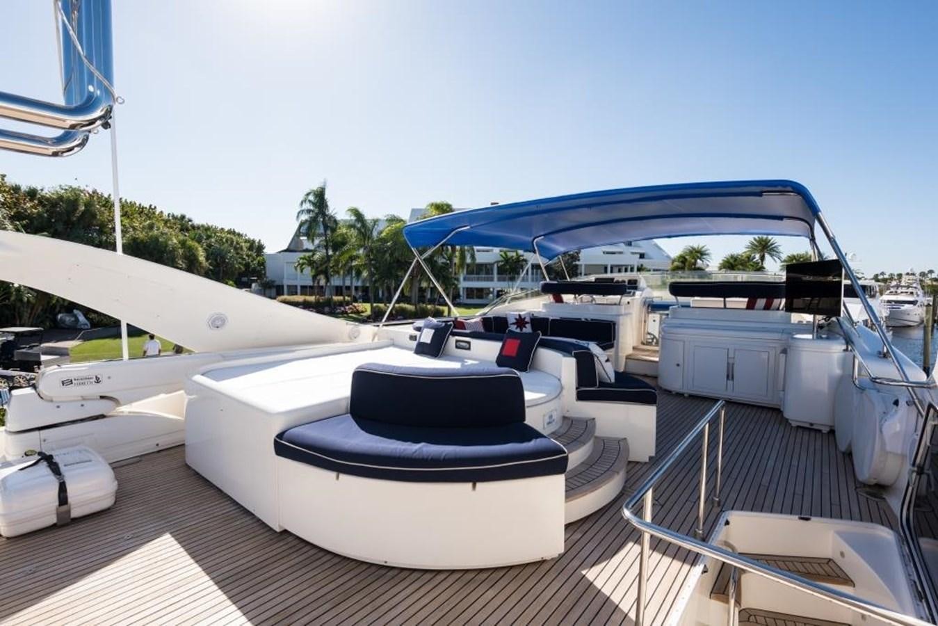 a deck with a pool and a building in the background aboard TOMORROW WE RIDE Yacht for Sale