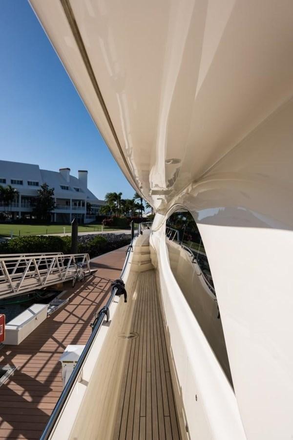 a deck with a railing and a building in the background aboard TOMORROW WE RIDE Yacht for Sale