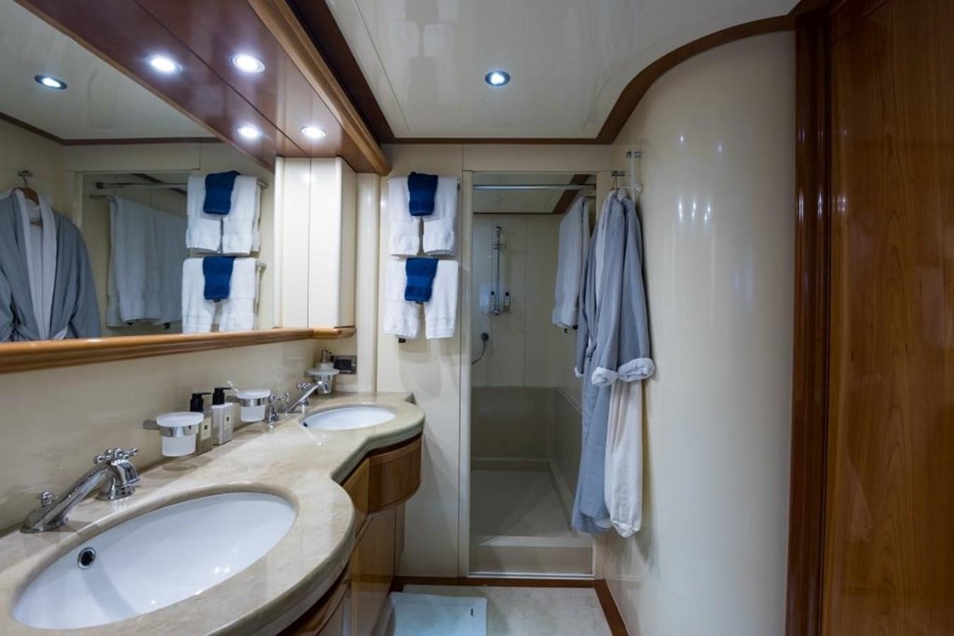 a bathroom with a shower sink and a mirror aboard TOMORROW WE RIDE Yacht for Sale
