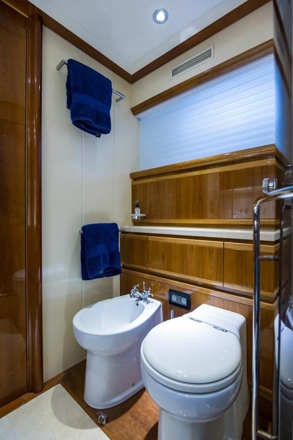 a bathroom with a toilet and a sink aboard TOMORROW WE RIDE Yacht for Sale