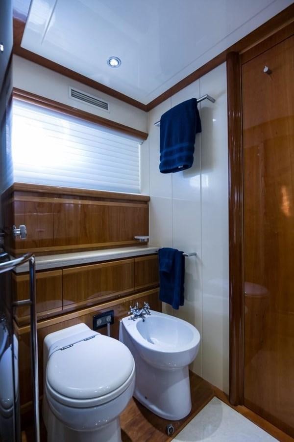 a bathroom with a toilet and a sink aboard TOMORROW WE RIDE Yacht for Sale