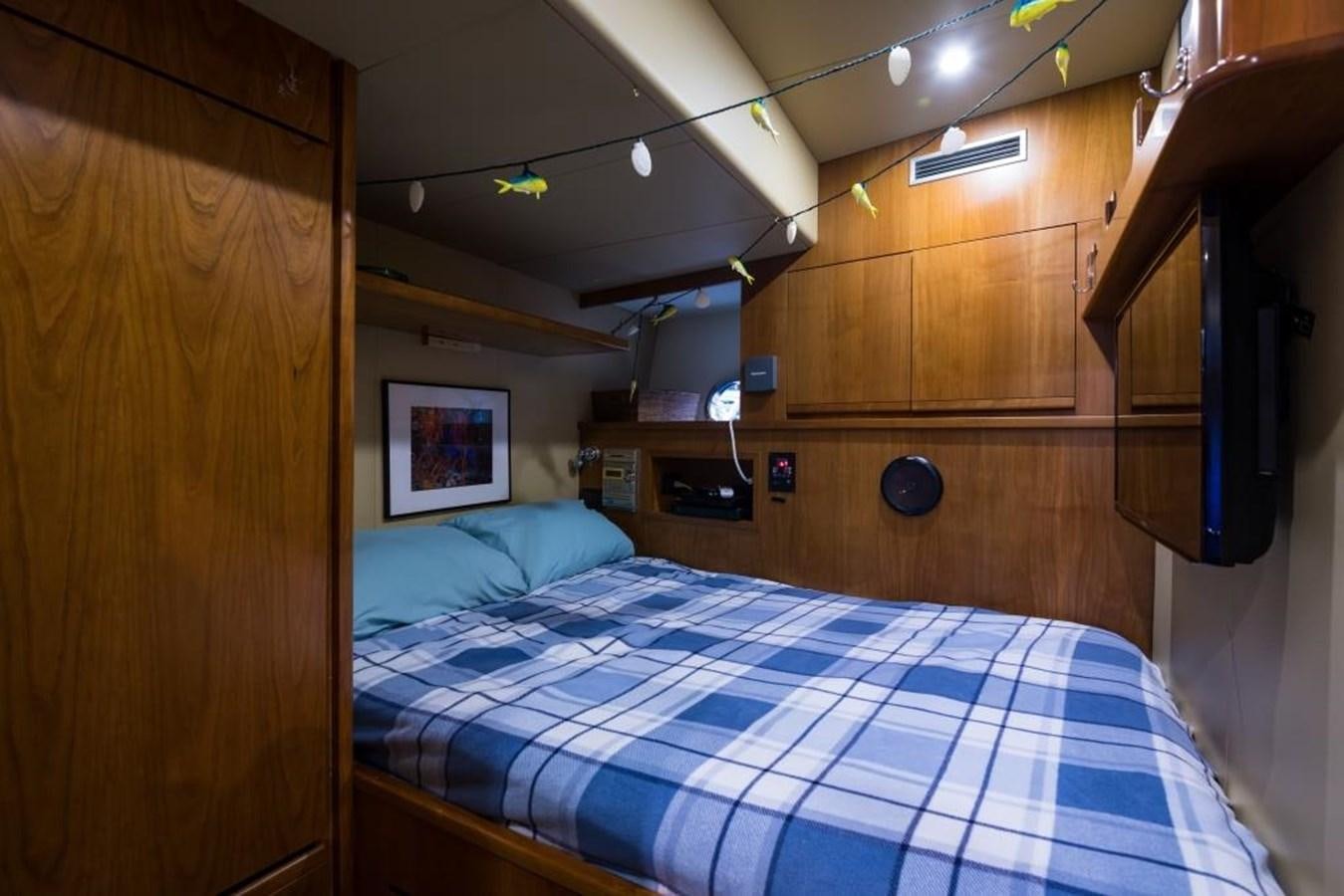 a bedroom with a bed and a desk aboard TOMORROW WE RIDE Yacht for Sale