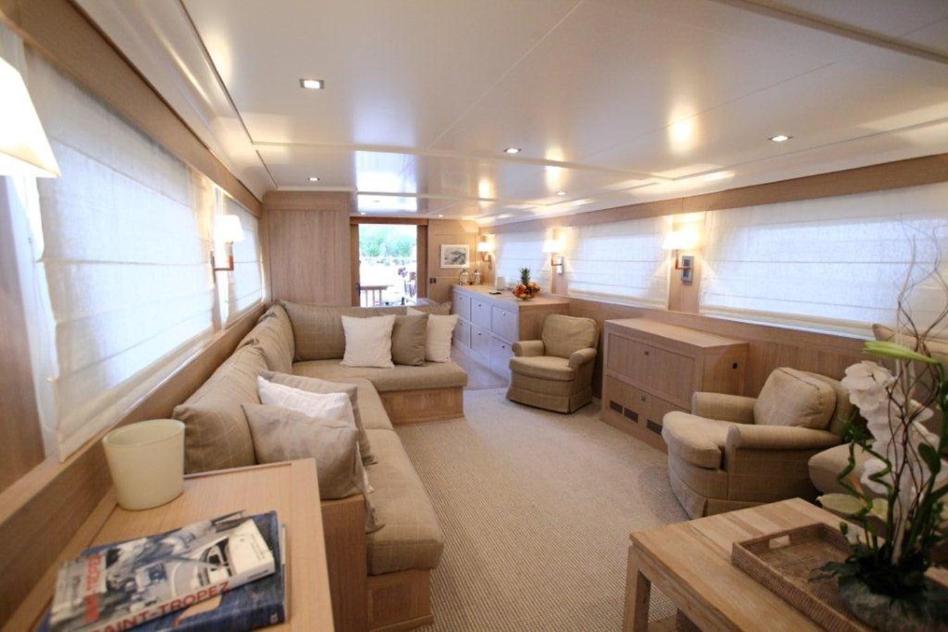 a living room with a couch and a table aboard CONQUEST OF 1966 Yacht for Sale