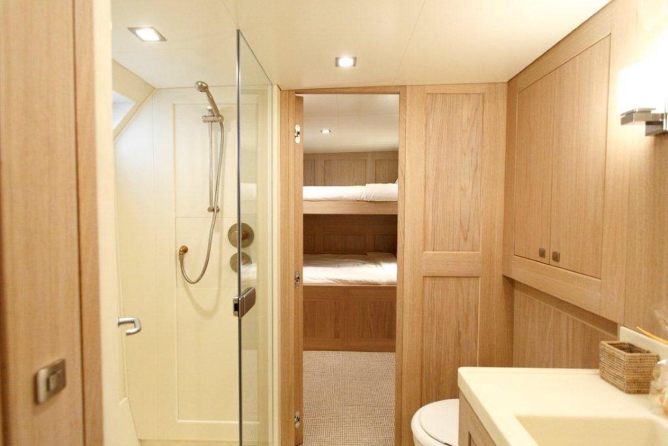 a bathroom with a shower unit and a sink aboard CONQUEST OF 1966 Yacht for Sale