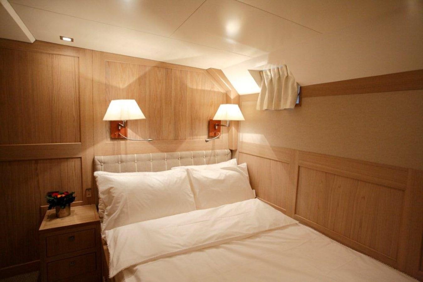 a bed with white sheets aboard CONQUEST OF 1966 Yacht for Sale