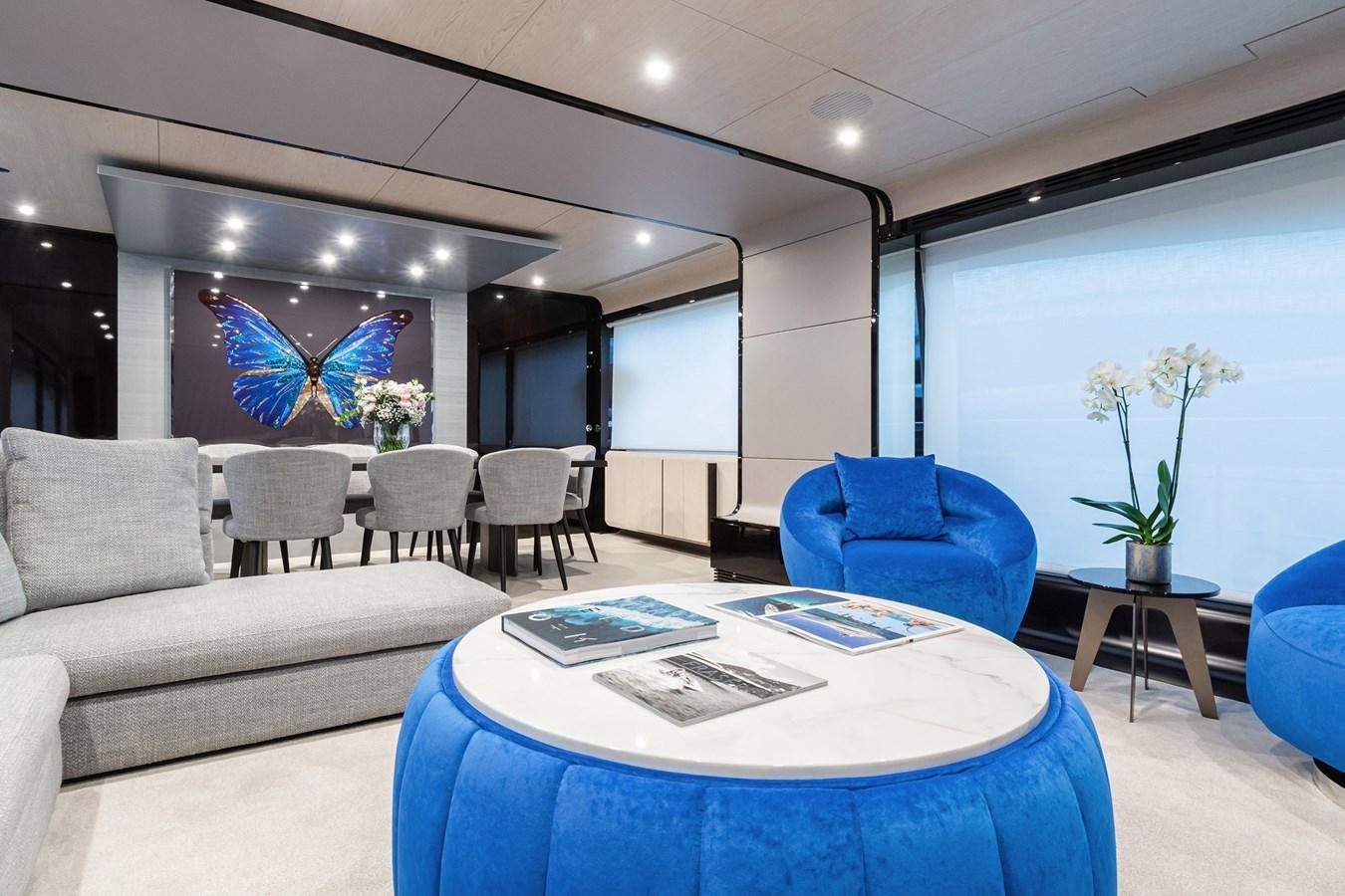 a room with a couch and a table and chairs aboard SOLSTICE Yacht for Sale