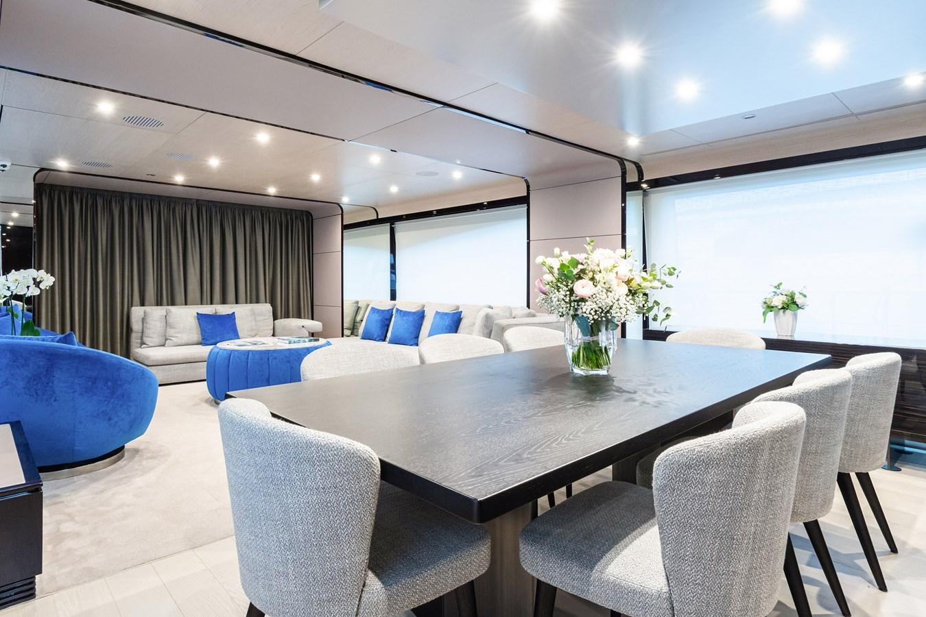 a room with a table chairs and a couch aboard SOLSTICE Yacht for Sale