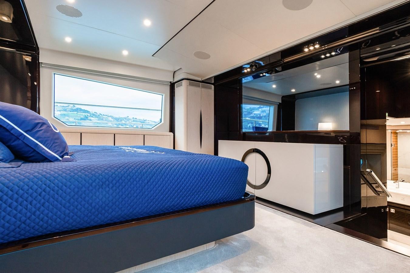 a bedroom with a bed and a window aboard SOLSTICE Yacht for Sale