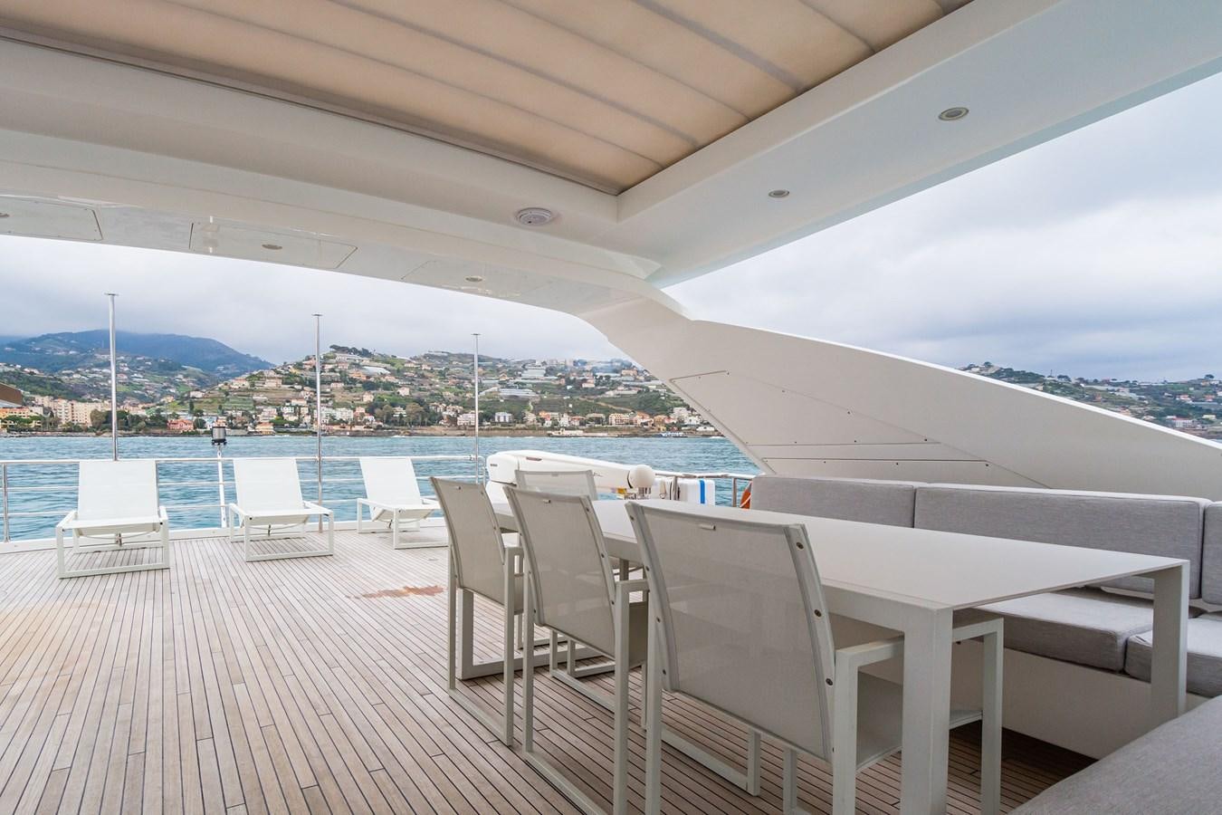 a deck with chairs and a view of a city aboard SOLSTICE Yacht for Sale