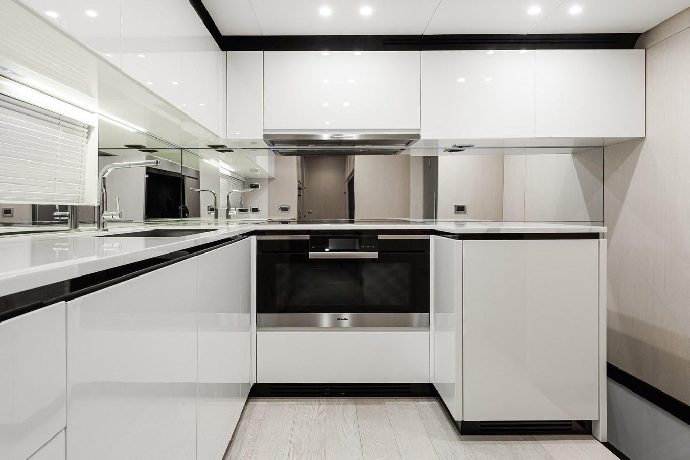 a kitchen with white cabinets aboard SOLSTICE Yacht for Sale