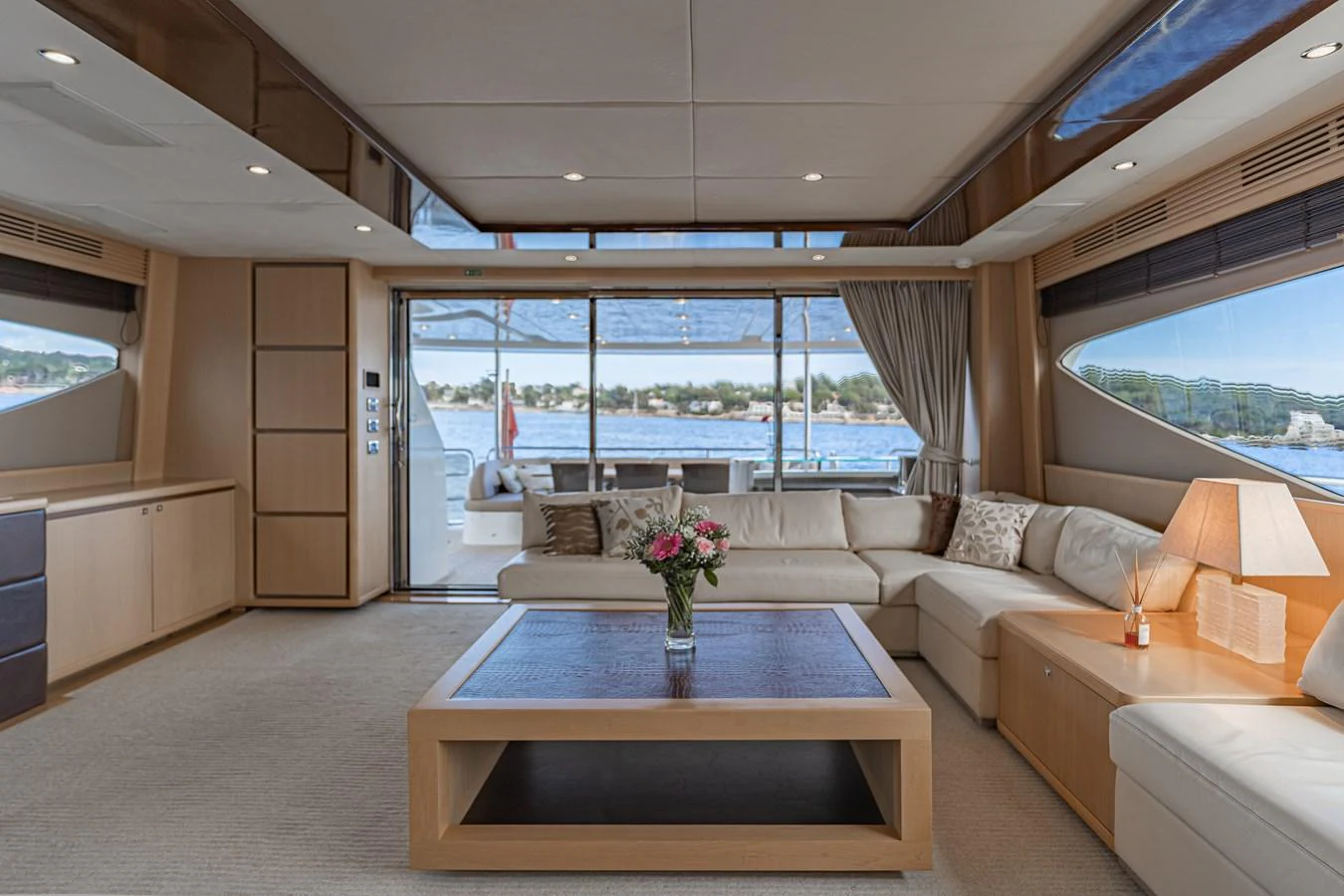 a living room with a table and couches aboard BLUE EYES Yacht for Sale