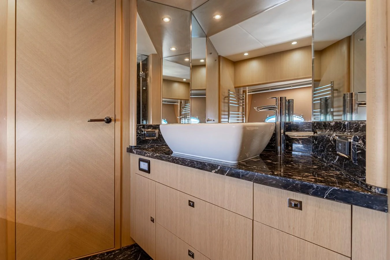a bathroom with a sink and a large mirror aboard BLUE EYES Yacht for Sale