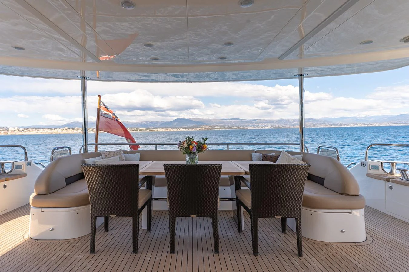 a table and chairs on a deck overlooking a body of water aboard BLUE EYES Yacht for Sale