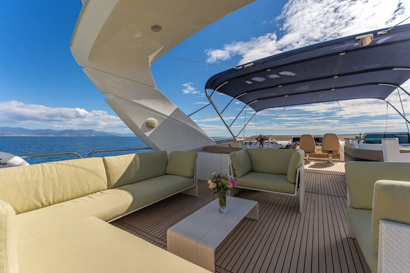 a large white lounge chair on a deck overlooking the ocean aboard BLUE EYES Yacht for Sale