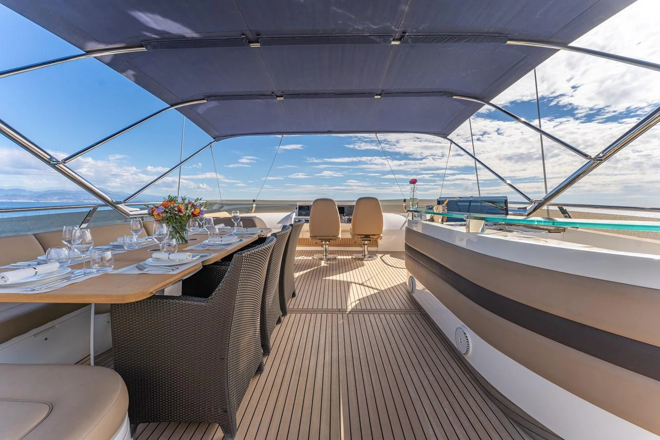a deck with a table and chairs aboard BLUE EYES Yacht for Sale