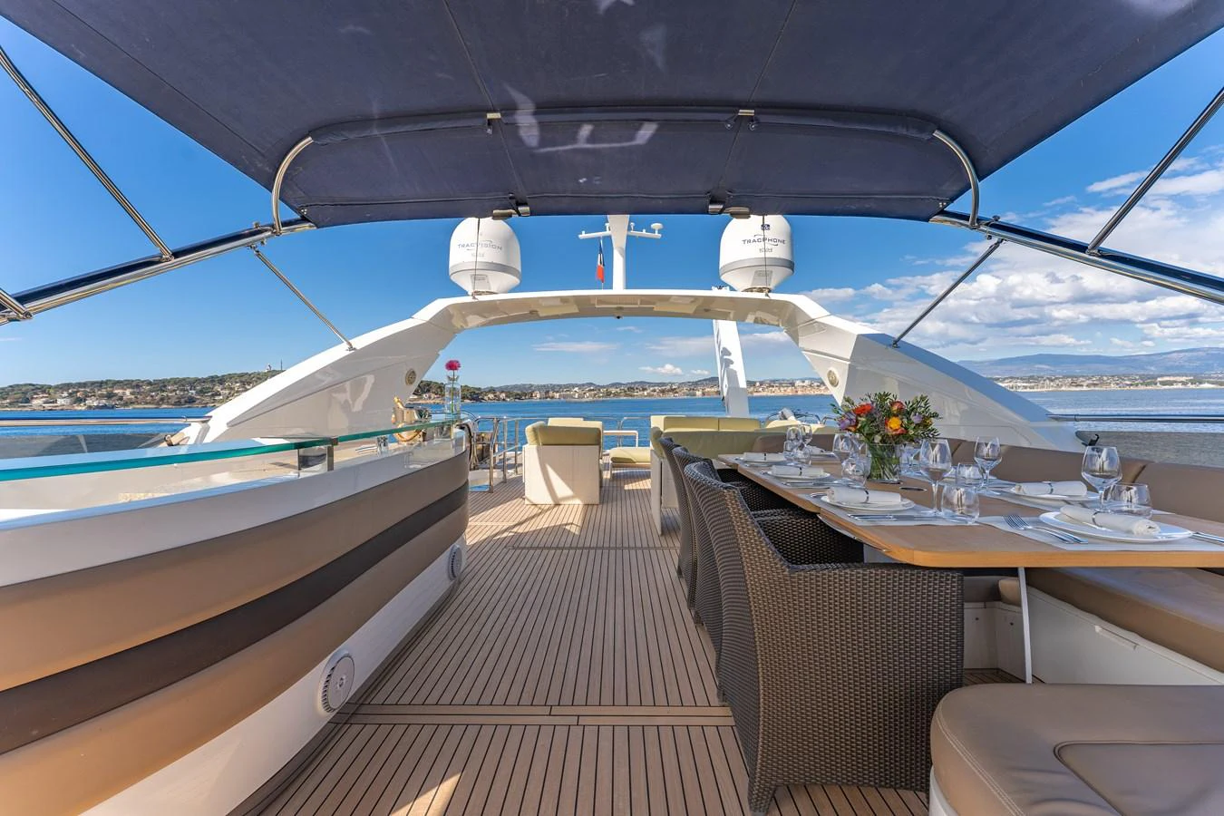 a deck with a table and chairs on it aboard BLUE EYES Yacht for Sale