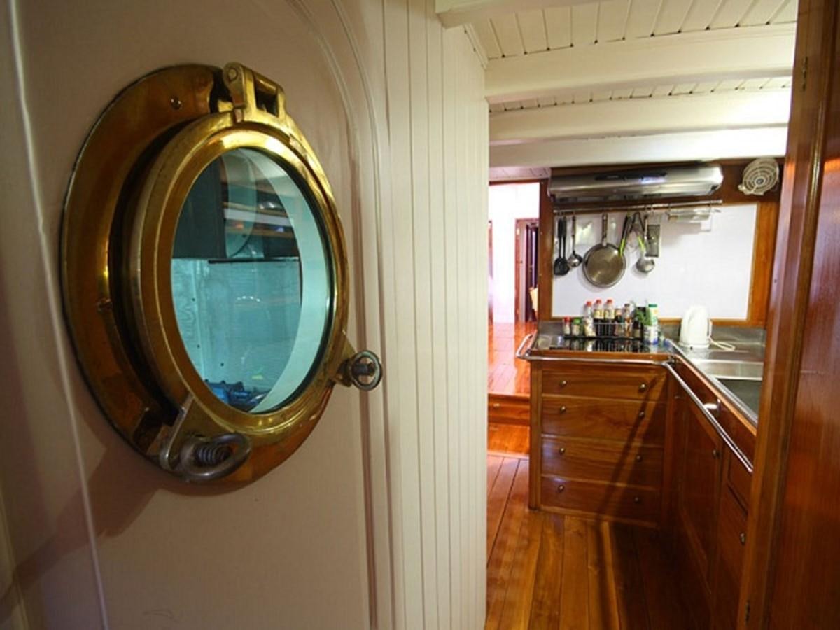 a large round mirror in a kitchen aboard AVENTURE Yacht for Sale