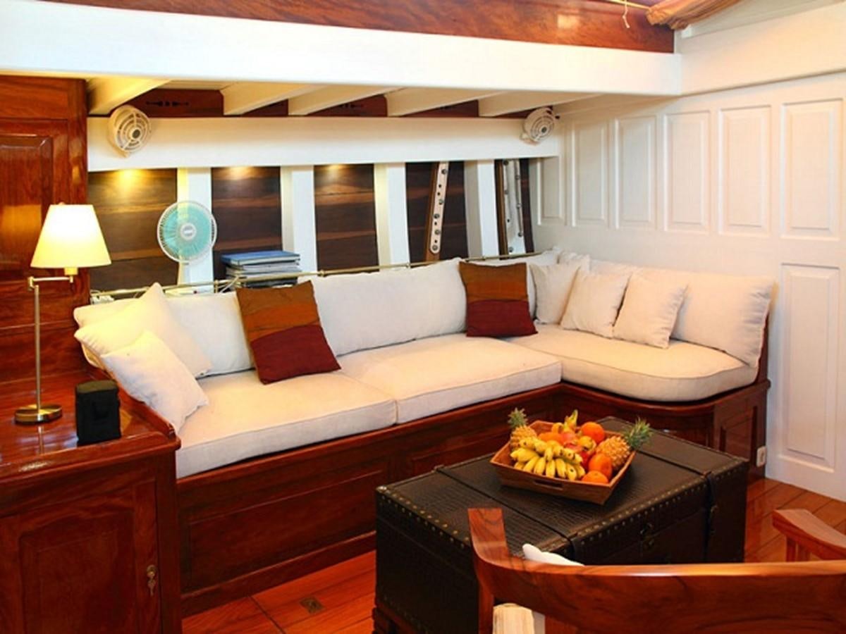 a living room with a couch and a coffee table aboard AVENTURE Yacht for Sale