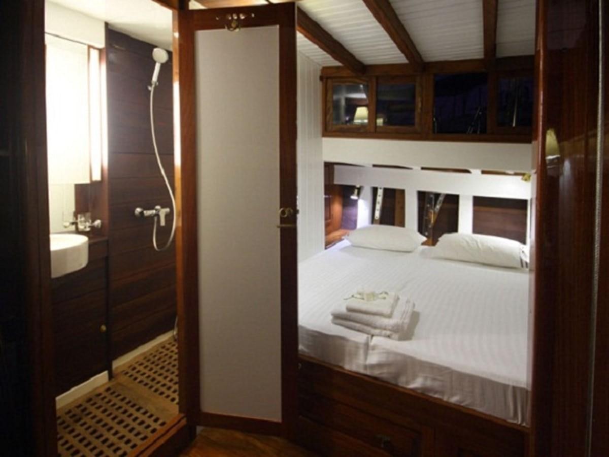 a bedroom with a bed aboard AVENTURE Yacht for Sale