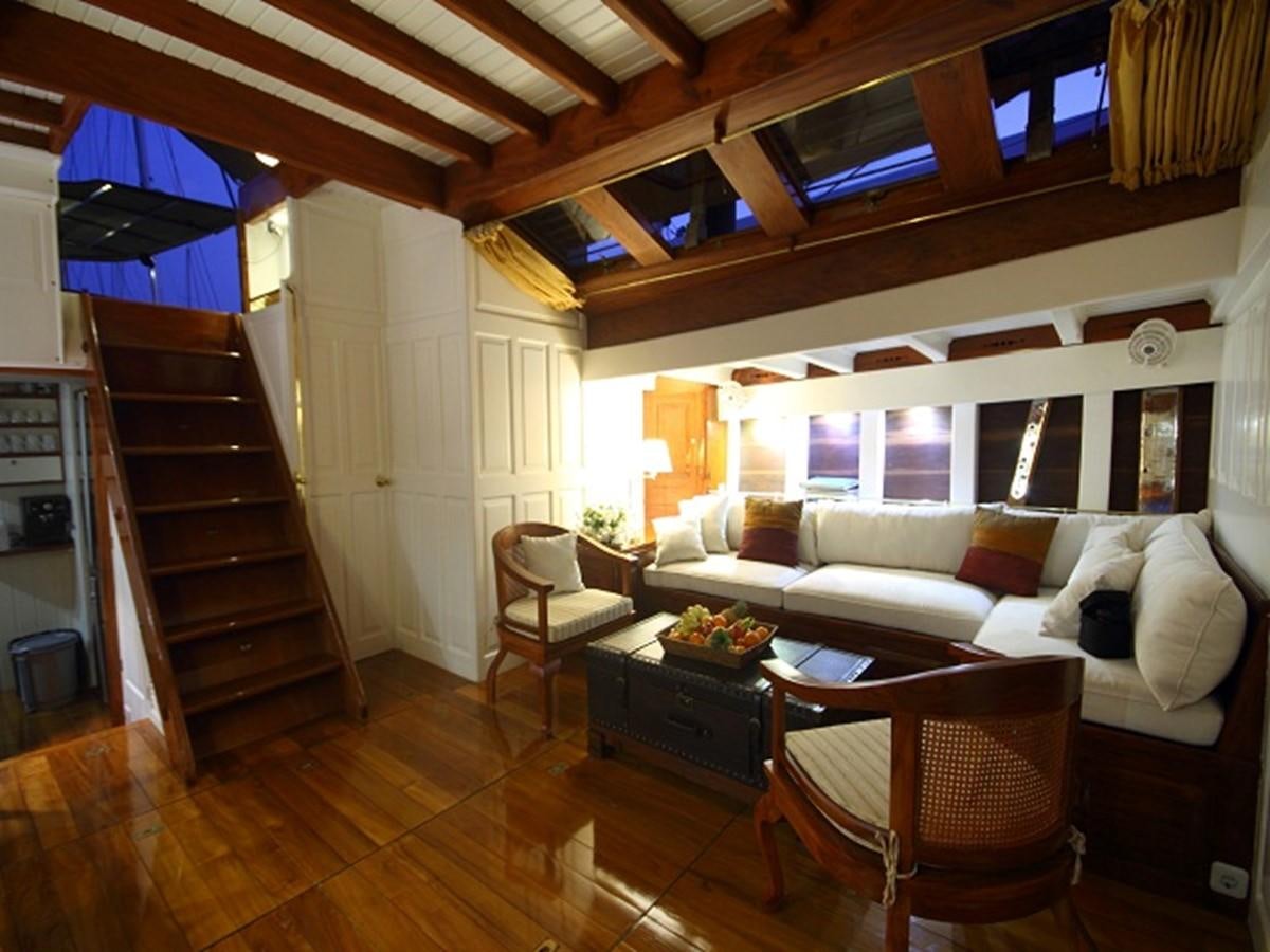 a living room with a couch and a table aboard AVENTURE Yacht for Sale