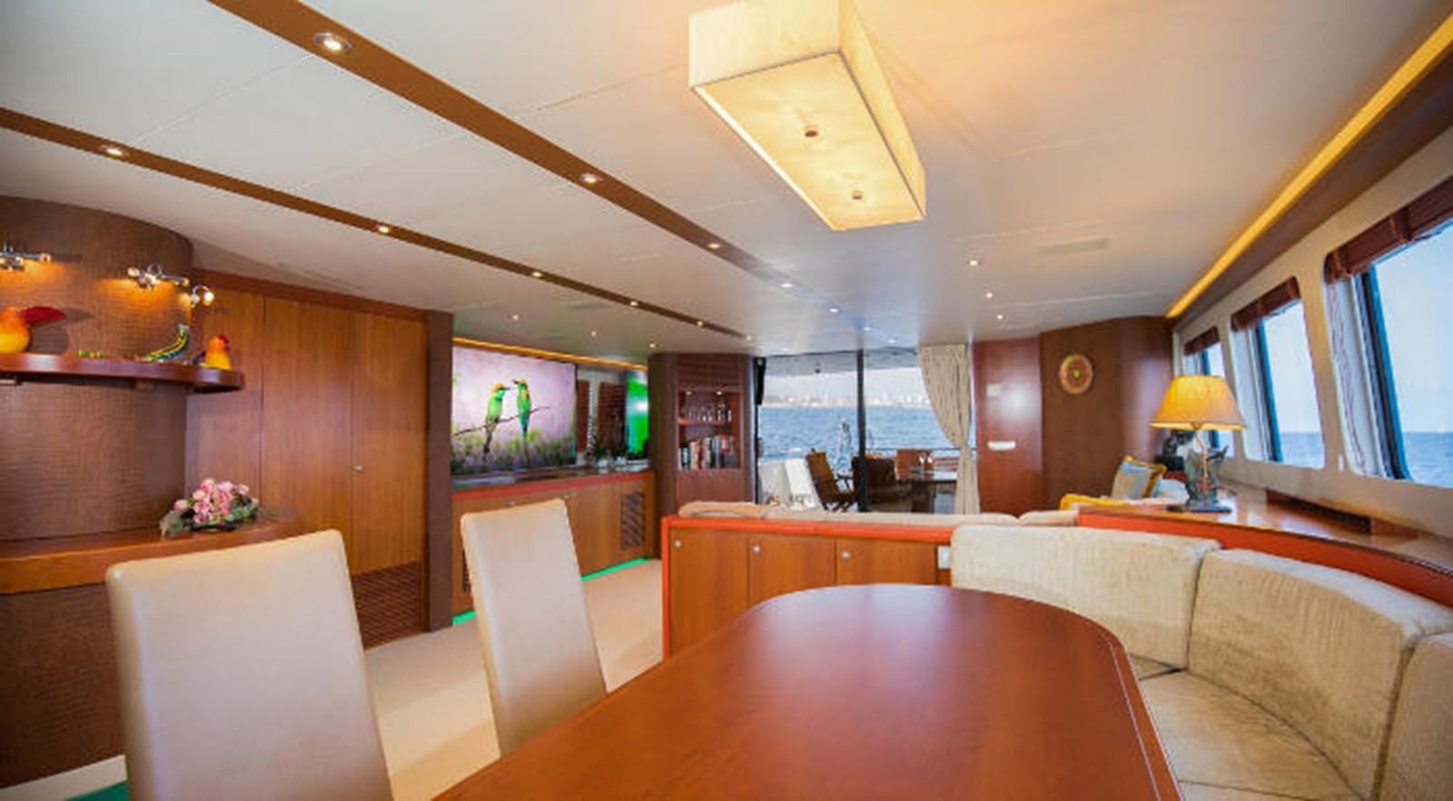 a living room with a table and chairs aboard HEARTBEAT OF LIFE Yacht for Sale