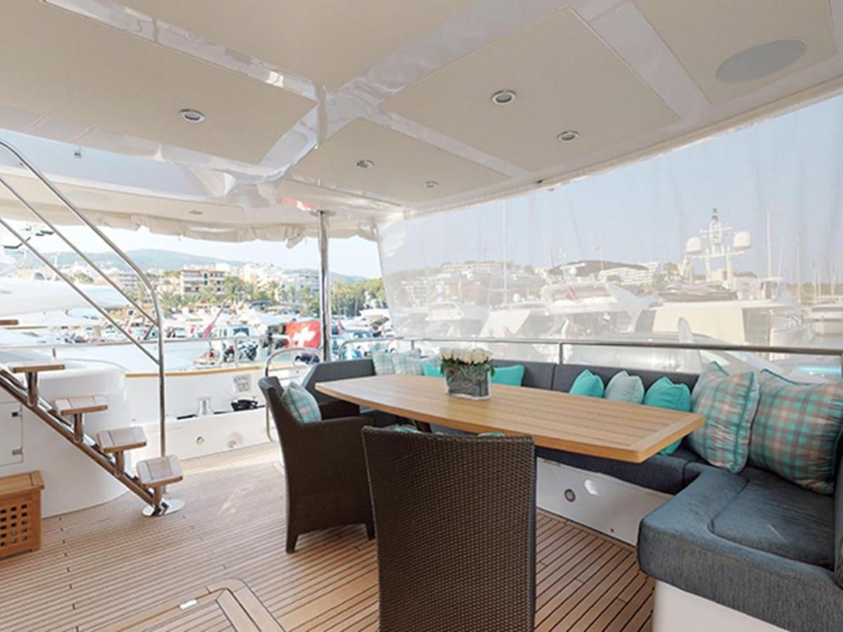 a room with a table and chairs aboard SKI Yacht for Sale