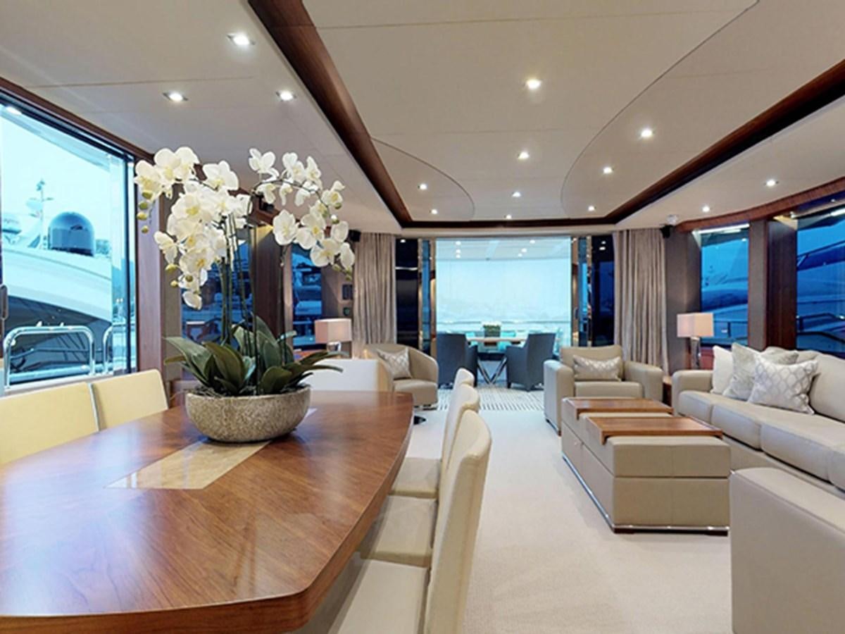 a large living room with a large table and chairs aboard SKI Yacht for Sale