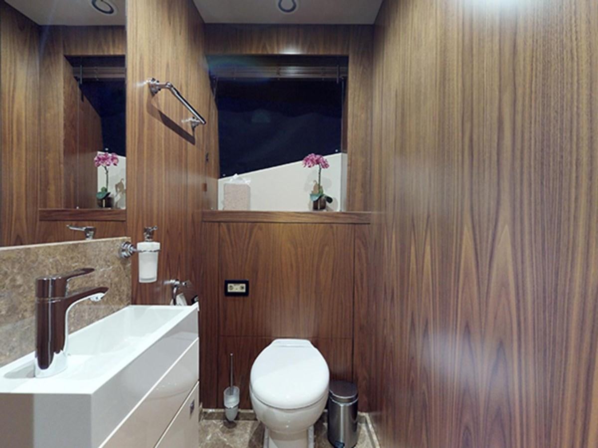 a bathroom with a toilet sink and a mirror aboard SKI Yacht for Sale