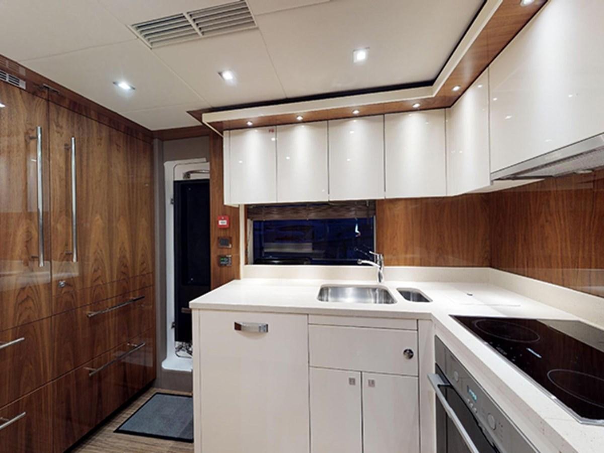 a kitchen with wooden cabinets aboard SKI Yacht for Sale