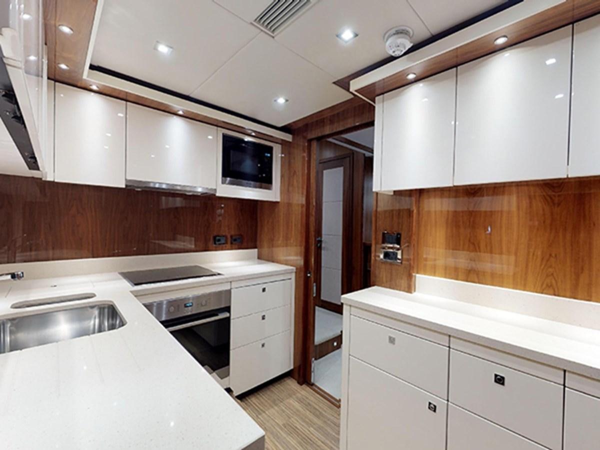 a kitchen with white cabinets aboard SKI Yacht for Sale