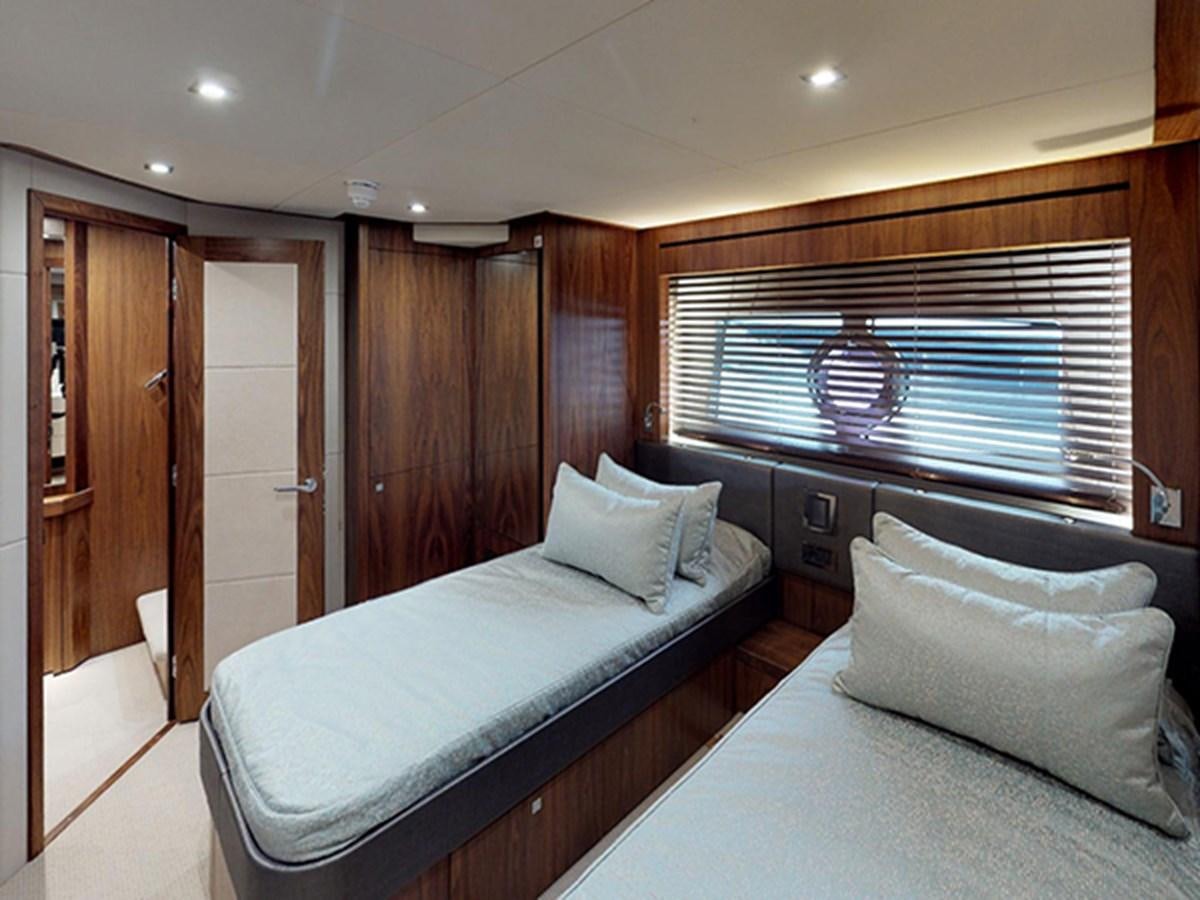 a bedroom with a bed and a window aboard SKI Yacht for Sale